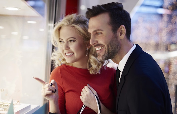 Couple looking through stores window